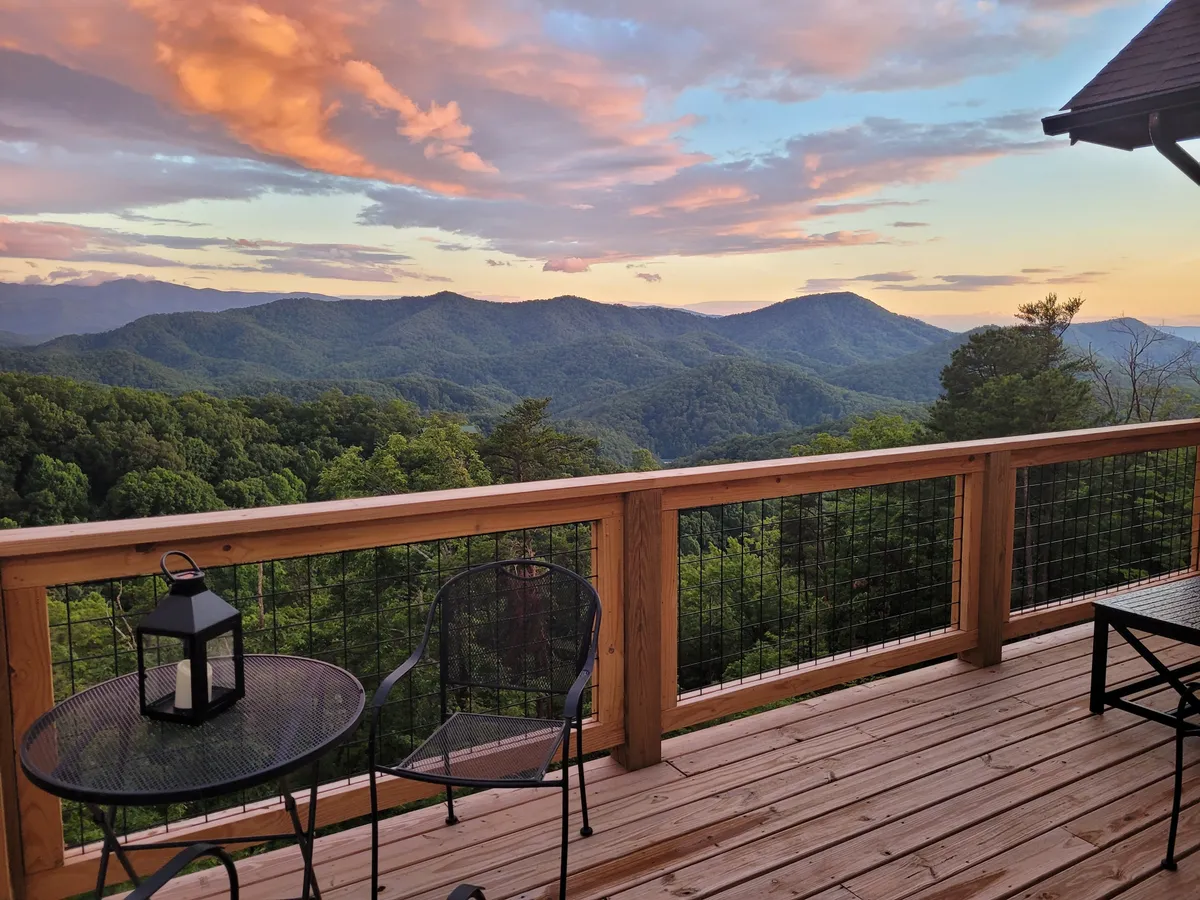 A tranquil outdoor seating area on a deck, framed by a stunning mountain view. The setting encourages relaxing, gathering with family, and soaking in the natural beauty—an ideal spot for unwinding after a day of exploring.